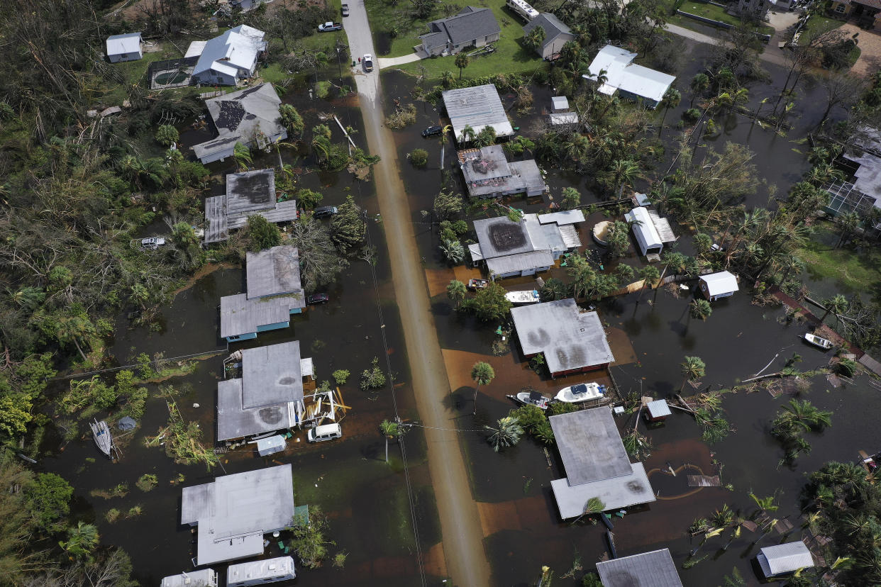 Aerial view of a dozen flooded homes and roads.