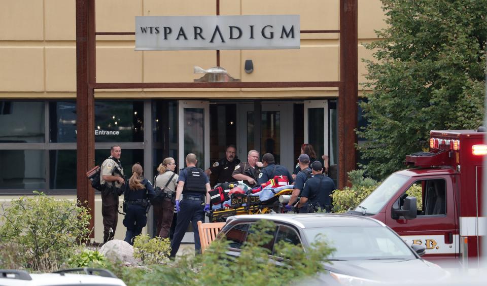 Emergency personnel arrive on the scene of a shooting at a software company in Middleton.  Four people were shot and wounded during the shooting in the suburb of Madison, according to a city administrator.