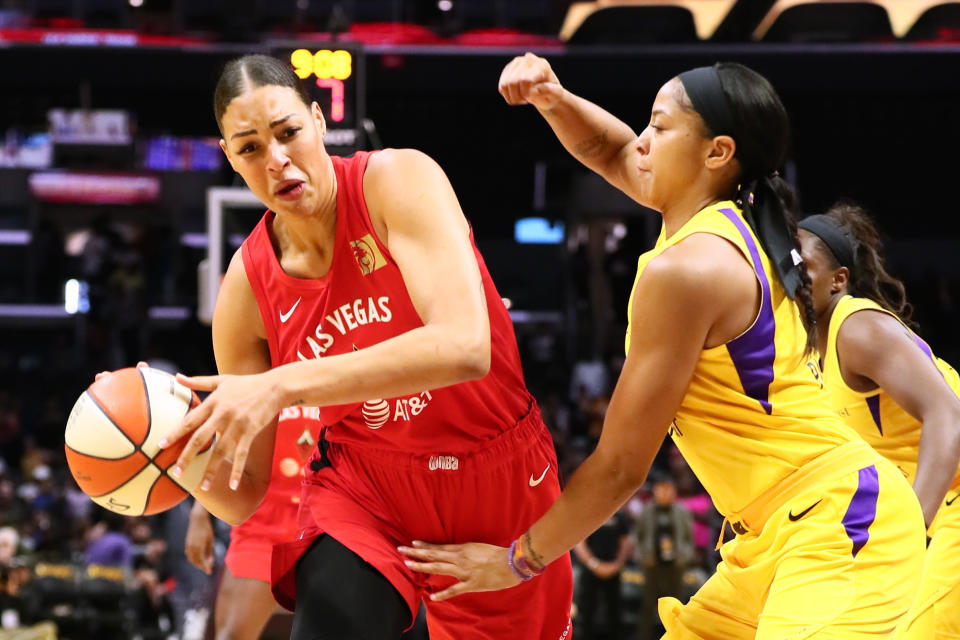 LOS ANGELES, CALIFORNIA - JUNE 27: Liz Cambage #8 of the Las Vegas Aces handles the ball against Candace Parker #3 of the Los Angeles Sparks during a WNBA basketball game at Staples Center on June 27, 2019 in Los Angeles, California. (Photo by Leon Bennett/Getty Images)