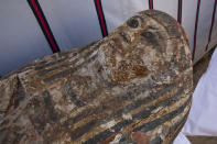 An ancient coffin is on display that Egyptian archaeologist Zahi Hawass and his team unearthed in a vast necropolis filled with burial shafts, coffins and mummies dating back to the New Kingdom 3000 BC, Monday, Jan. 17, 2021, in Saqqara, south of Cairo, Egypt. (AP Photo/Nariman El-Mofty)