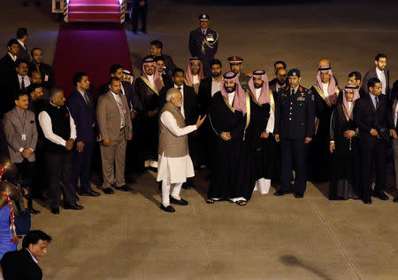 India's Prime Minister Narendra Modi talks to Saudi Arabia's Crown Prince Mohammed bin Salman upon his arrival at an airport in New Delhi, India, February 19, 2019. REUTERS/Adnan Abidi