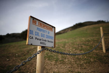 A gas company sign marks a fence near the site of the Aliso Canyon storage field where gas has been leaking in Porter Ranch, California, United States, January 21, 2016. REUTERS/Lucy Nicholson