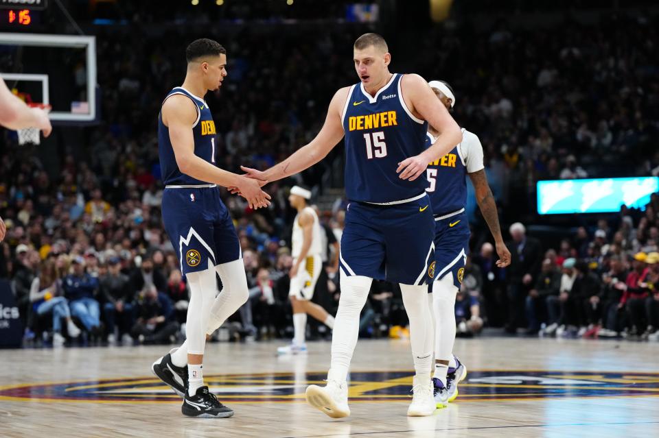Jan 14, 2024; Denver, Colorado, USA; Denver Nuggets forward Michael Porter Jr. (1) and center Nikola Jokic (15) during the fourth quarter against the Indiana Pacers at Ball Arena. Mandatory Credit: Ron Chenoy-USA TODAY Sports