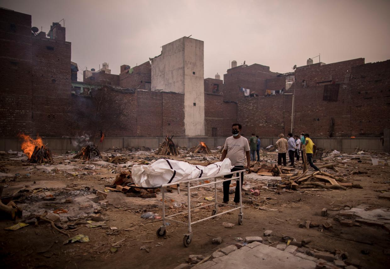 Family members of a person who died of COVID-19 perform the last rites at a crematorium on May 09, 2021, in New Delhi, India.