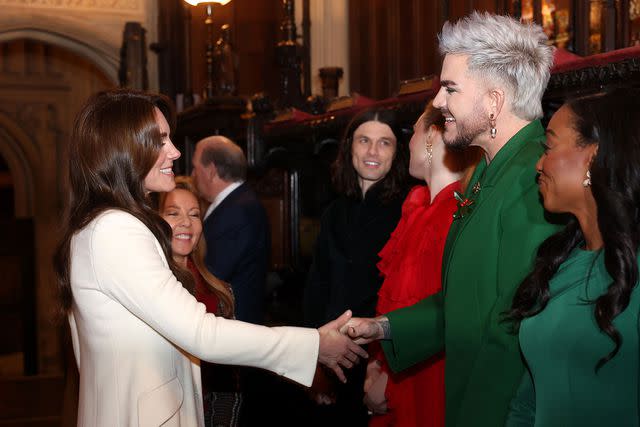 <p>Chris Jackson/Getty</p> Kate Middleton chats with Adam Lambert at the Together At Christmas concert at Westminster Abbey in London on Dec. 8.