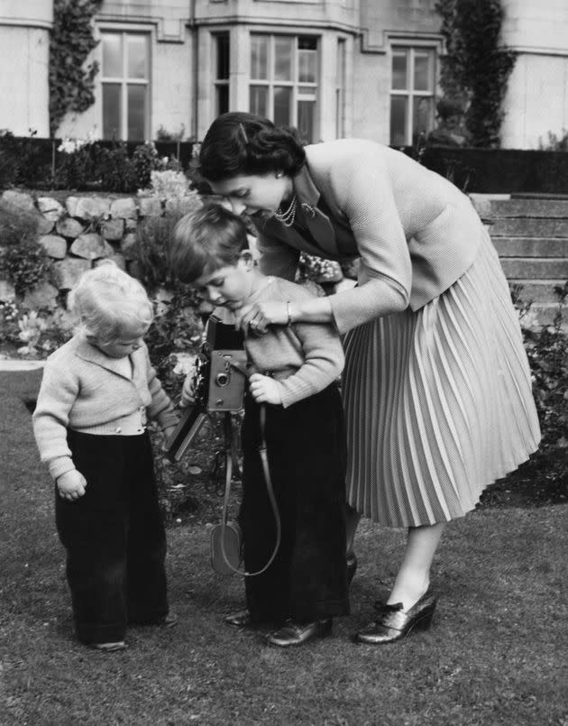 Queen Elizabeth II helps Prince Charles take a picture of his sister, Princess Anne, in Balmoral, Scotland, in 1952. (Photo: Lisa Sheridan via Getty Images)