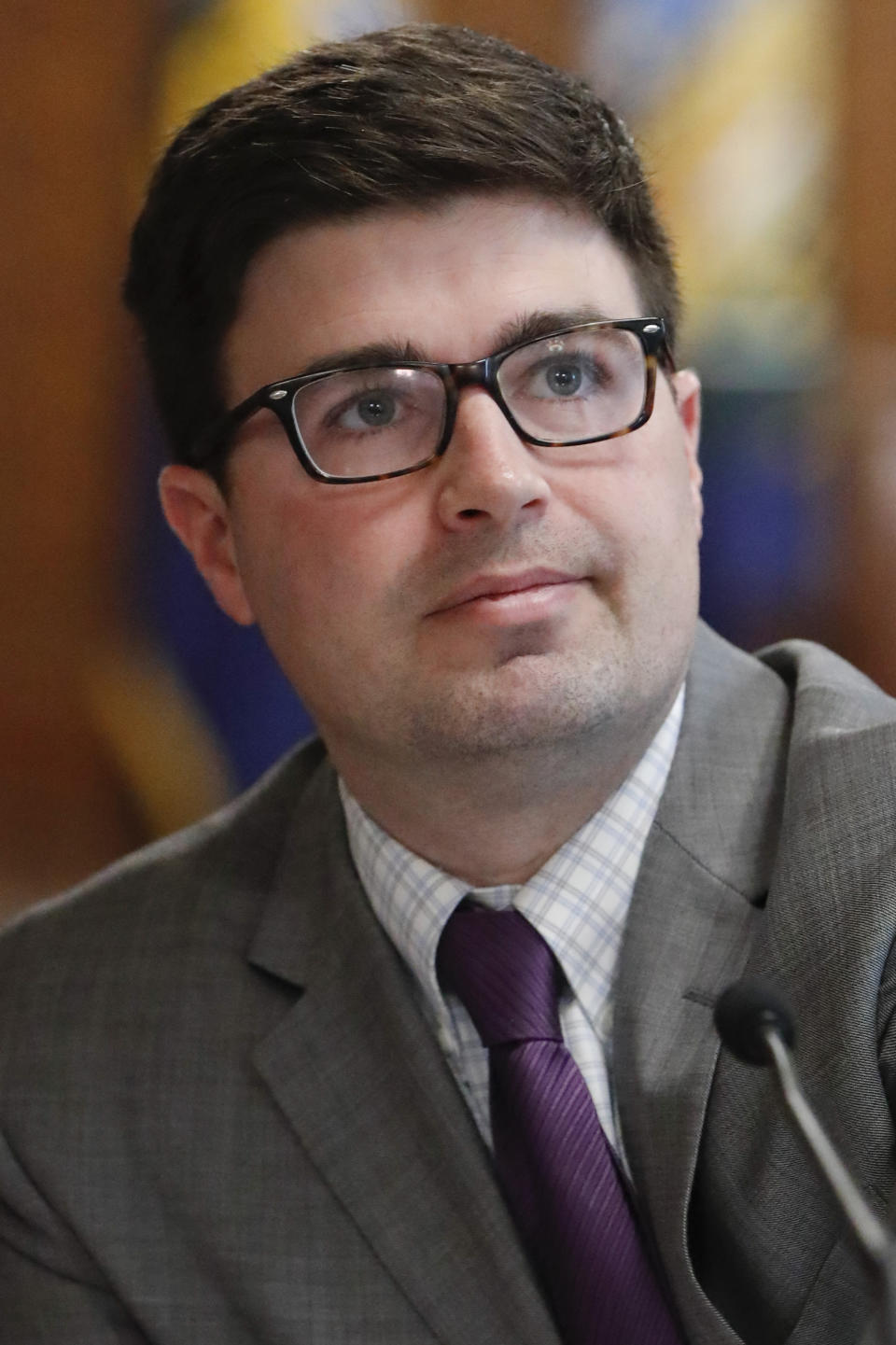 Pittsburgh city council member Corey O'Connor listens as fellow council members speak during the Pittsburgh City Council meeting where members voted 6-3 to pass tentative approval to gun-control legislation he co-sponsored, Wednesday, March 27, 2019, in Pittsburgh. The bill was introduced in the wake of the synagogue massacre last October. (AP Photo/Keith Srakocic)