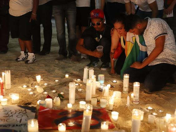 Mourners in Florida pay their respects at a memorial for the Pulse nightclub shooting, in which Omar Mateen killed 49 people (Getty)