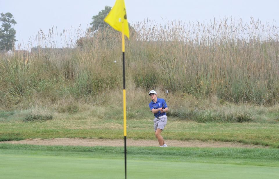 Wynford's Micah Green hits out of the sand on No. 8 at Stone Ridge in the Division III district tournament.