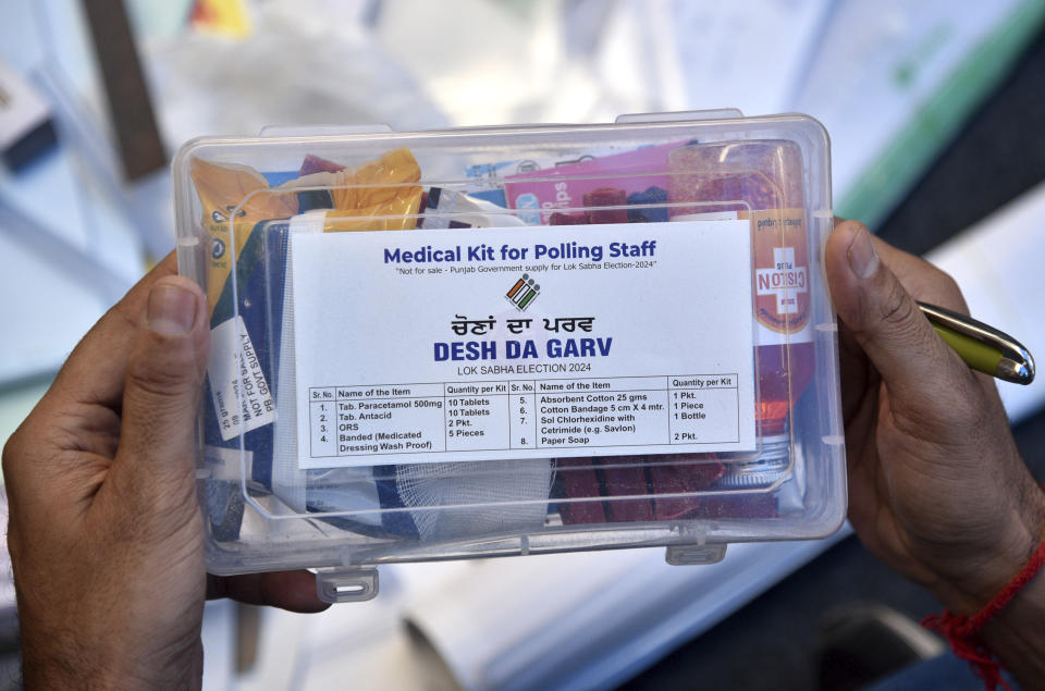 A polling official checks his medical kit prior to leaving for his assigned polling booth on the eve of the seventh and final phase of India's national election in Amritsar, India, Friday, May 31, 2024. Officials say a scorching heat wave has killed at least 14 people, including 10 election officials, in eastern India with temperatures soaring up to 49.9 degrees Celsius (122 degrees Fahrenheit) in parts of India this week. (AP Photo/Prabhjot Gill)