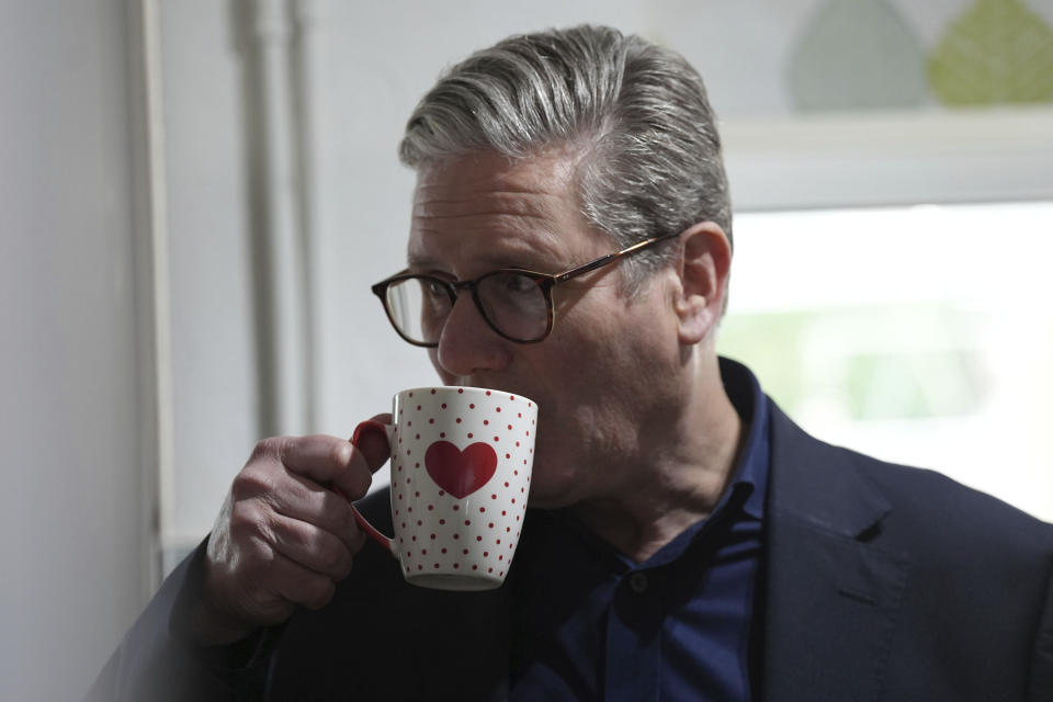 British Labour Party leader Sir Keir Starmer has a drink as he speaks to voters about the cost of living, while on the General Election campaign trail in Stafford, in the West Midlands, England, Saturday May 25, 2024. ( Jacob King/PA via AP)