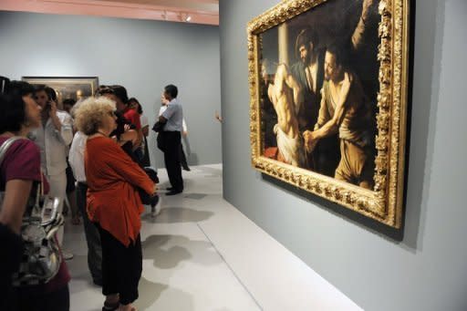 Visitors look at a painting by Italian artist Michelangelo Merisi, known as Caravaggio, in June 2012 at the Fabre Museum in Montpellier, France. Italian art experts have reportedly discovered around 100 drawings and a number of paintings by the young Renaissance master Caravaggio in a find that could be worth up to 700 million euros