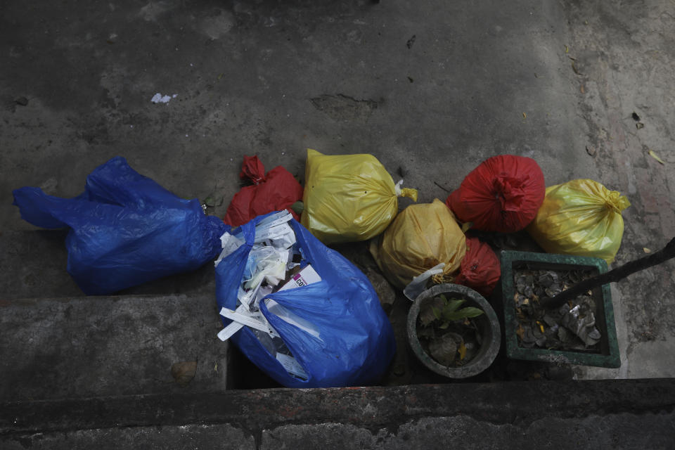 Garbage material of COVID-19 tests are kept aside for disposal in New Delhi, India, Tuesday, Sept. 1, 2020. India has now reported more than 75,000 infections for five straight days, one of the highest in the world, just as the government began easing restrictions to help the battered economy. (AP Photo/Manish Swarup)