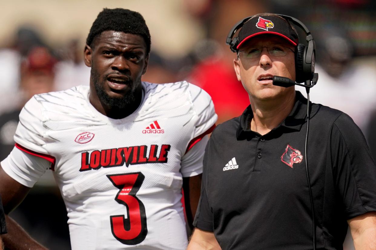 Louisville head coach Scott Satterfield and quarterback Malik Cunningham watch a replay during the first half of an NCAA college football game against Wake Forest on Saturday, Oct. 2, 2021, in Winston-Salem, N.C. (AP Photo/Chris Carlson)