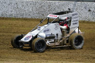 Jeff Gordon, a five-time winner of the Brickyard 400 and four-time NASCAR Cup Series champion, drives through a turn in a USAC midget car during an exhibition on the dirt track in the infield a Indianapolis Motor Speedway in Indianapolis, Thursday, June 17, 2021. (AP Photo/Michael Conroy)