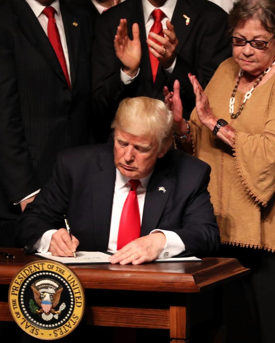 MIAMI, FL - JUNE 16: U.S. President Donald Trump signs policy changes he is making toward Cuba at the Manuel Artime Theater in the Little Havana neighborhood on June 16, 2017 in Miami, Florida. The President will re-institute some of the restrictions on travel to Cuba and U.S. business dealings with entities tied to the Cuban military and intelligence services. (Photo by Joe Raedle/Getty Images)