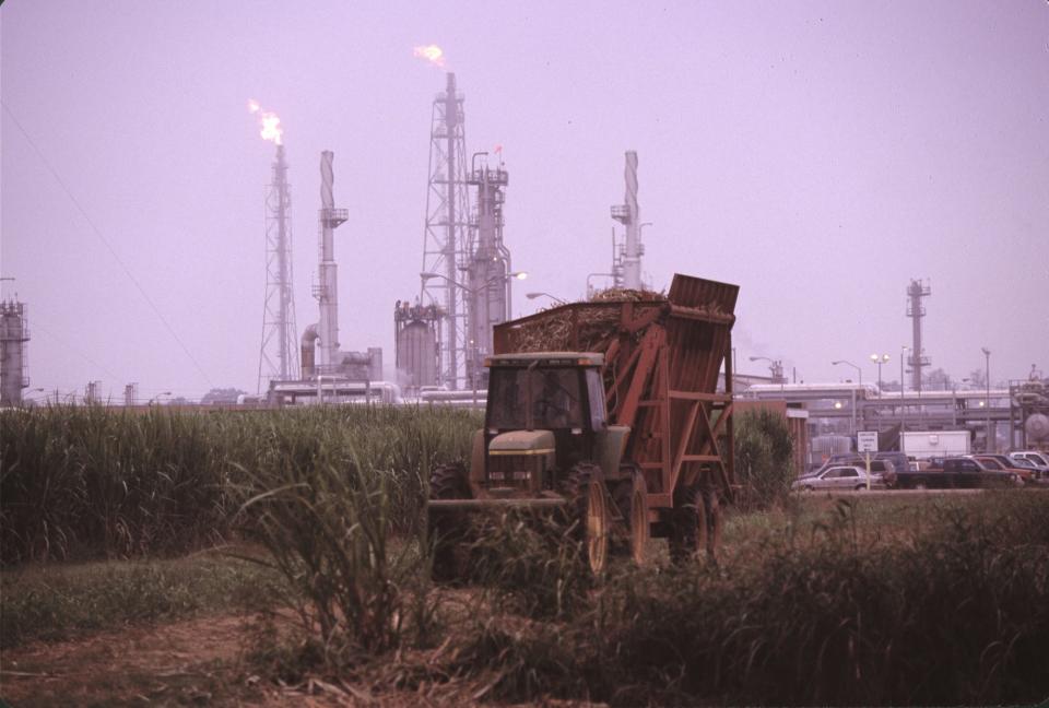Oil and chemical refinery plants cover the landscape, next to African American communities along the Mississippi River, October, 1998, near Baton Rouge, Louisiana.