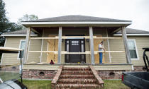Curt Duhon boards up windows on his son's house to prepare for Hurricane Delta Thursday, Oct. 8, 2020, north of Abbeville, La. (Leslie Westbrook/The Advocate via AP)