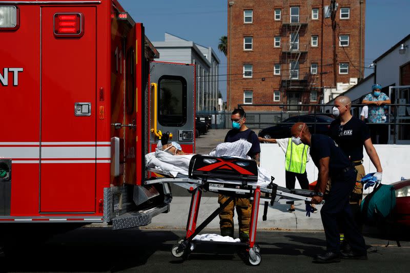 Los Angeles Fire Department (LAFD) emergency medical personnel transport a patient during the coronavirus disease (COVID-19) outbreak in Los Angeles