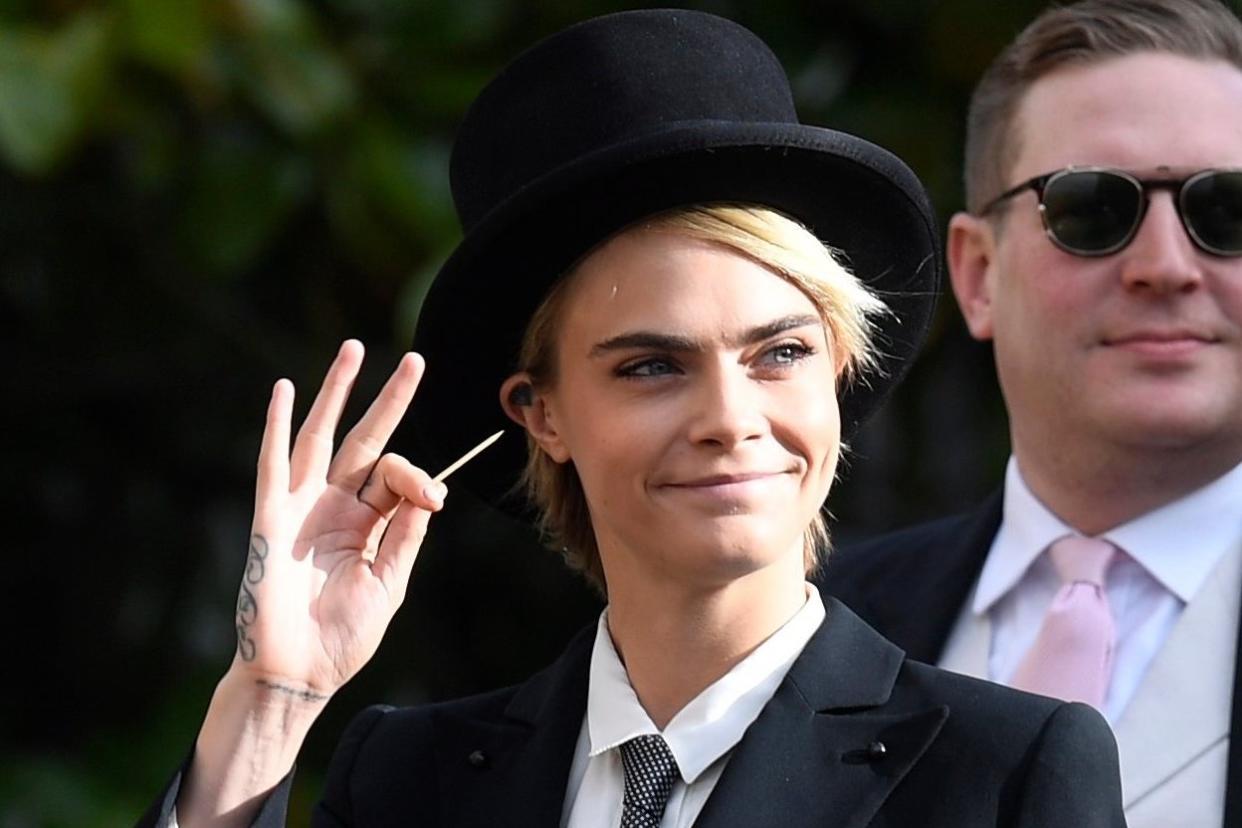 Bold move: Cara Delevingne in a top hat for Princess Eugenie's big day: EPA