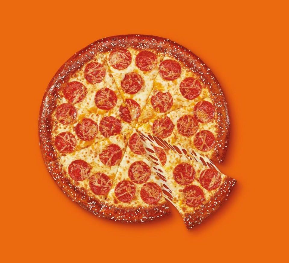 Little Caesars’ Pretzel Crust Pizza features a buttered pretzel crust topped with cheddar cheese sauce, Mozzarella and Muenster cheeses and pepperoni.