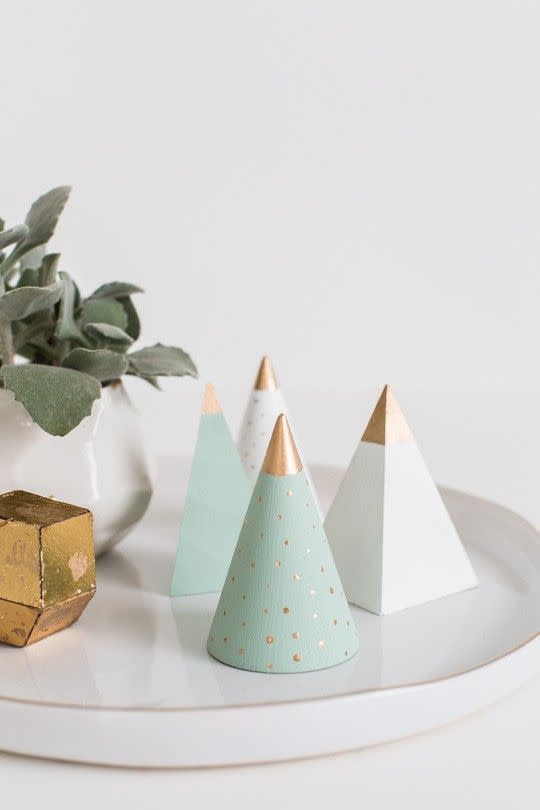 <p>A must-make for any modern decor addict, these are a fun arts and crafts project for a cozy afternoon. Get the tutorial at <a href="https://sugarandcloth.com/diy-mini-wooden-christmas-trees/" rel="nofollow noopener" target="_blank" data-ylk="slk:Sugar & Cloth;elm:context_link;itc:0;sec:content-canvas" class="link ">Sugar & Cloth</a>.</p>