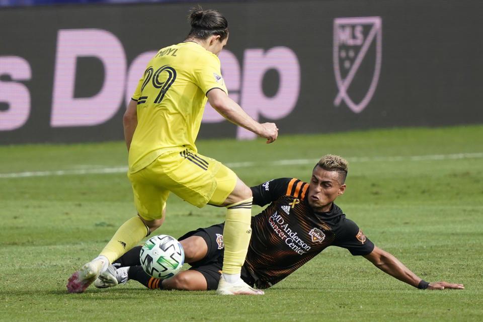 Houston Dynamo midfielder Darwin Ceren, right, slides into Nashville midfielder Alex Muyl (29) during the first half of an MLS soccer match Saturday, Sept. 26, 2020, in Nashville, Tenn. (AP Photo/Mark Humphrey)