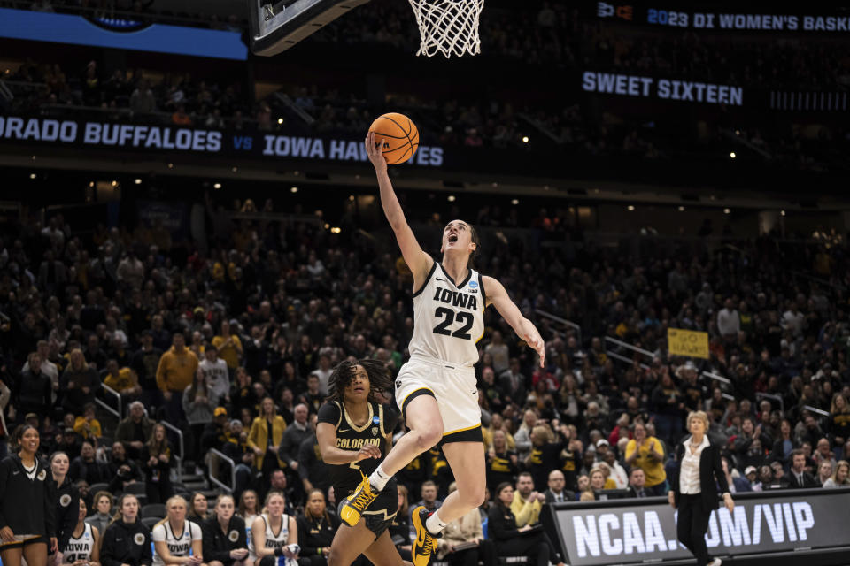 Iowa guard Caitlin Clark (22) goes up for a layup against Colorado guard Tameiya Sadler during the second half of a Sweet 16 college basketball game of the NCAA tournament, Friday, March 24, 2023, in Seattle. (AP Photo/Stephen Brashear)