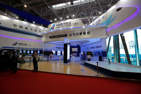 People stand near a booth of China Southern Airline at an air show, the China International Aviation and Aerospace Exhibition, in Zhuhai, Guangdong Province, China, November 2, 2016. Picture taken November 2, 2016. REUTERS/Stringer