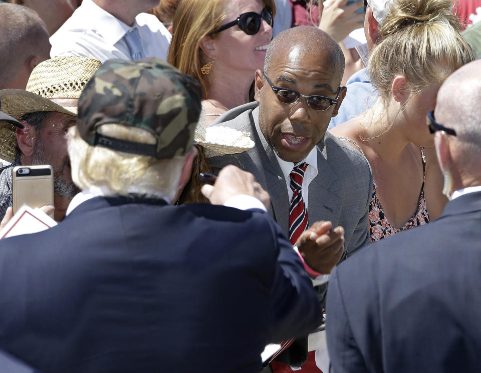 Republican presidential candidate Donald Trump talks to Gregory Cheadle at a rally on June 2, 2016.(AP Photo/Rich Pedroncelli)                                    