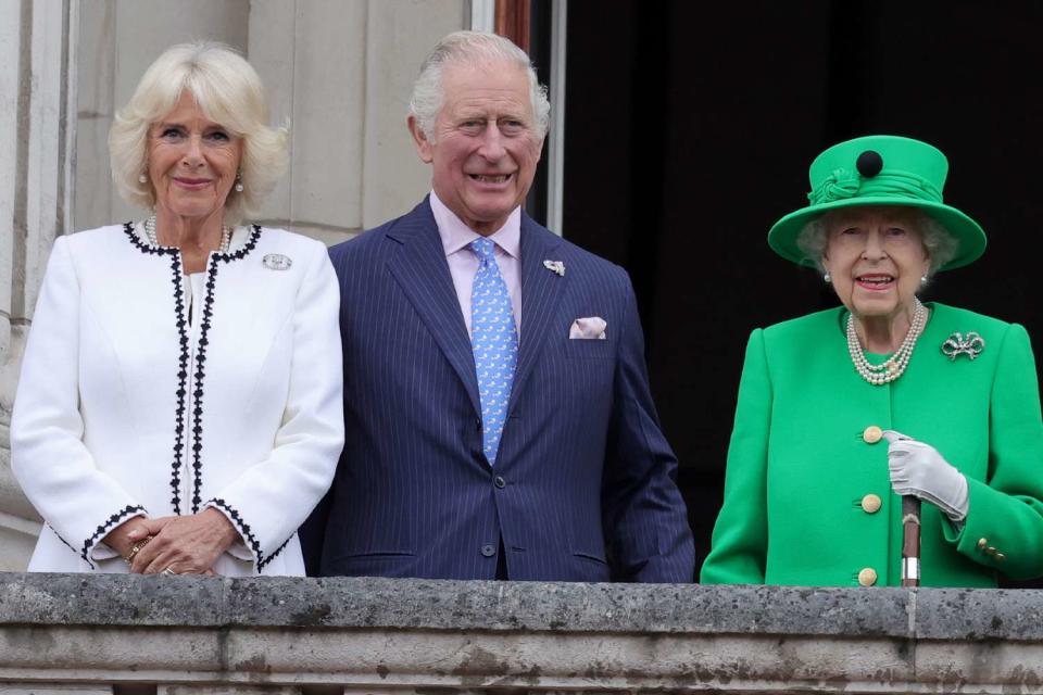 <p>WPA Pool/Getty </p> Queen Camilla and King Charles (then the Duchess of Cornwall and Prince of Wales) on the balcony of Buckingham Palace with Queen Elizabeth in June 2022. 