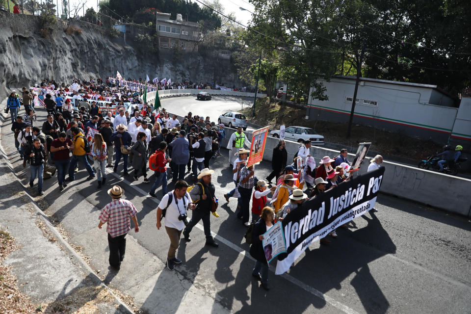 People attend a protest against violence coined “Walk for Peace" as they leave Cuernavaca, Mexico, Thursday, Jan. 23, 2020, with Mexico City as their destination. Activist and poet Javier Sicilia, being interviewed at the center of the photograph, is leading his second march against violence in Mexico, this time accompanied by members of the LeBaron family, and plan to reach Mexico's National Palace on Sunday. (AP Photo/Eduardo Verdugo)