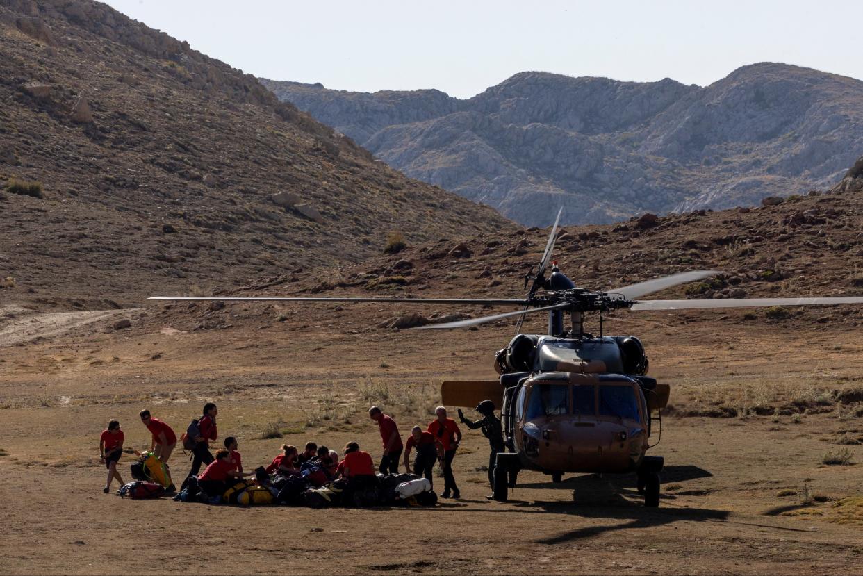 Rescuers arrive at a base camp to take part in the rescue operation for trapped explorer Mark Dickey (Umit Bektas/Reuters)