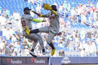 Atlanta Braves designated hitter Marcell Ozuna (20) and right fielder Ronald Acuna Jr. celebrate after the Braves beat the Miami Marlins, 9-7, in a baseball game, Sunday, April 14, 2024, in Miami. (AP Photo/Wilfredo Lee)