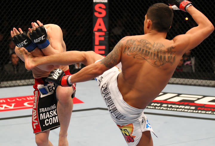 SAITAMA, JAPAN - FEBRUARY 26: (R-L) Anthony Pettis kicks Joe Lauzon during the UFC 144 event at Saitama Super Arena on February 26, 2012 in Saitama, Japan.