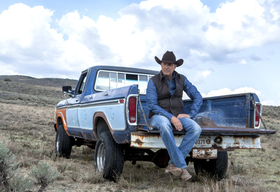 Kevin Costner sits on a truck in 