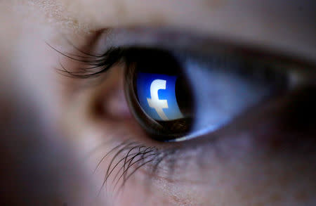 FILE PHOTO: A picture illustration shows a Facebook logo reflected in a person's eye, in Zenica, March 13, 2015. REUTERS/Dado Ruvic/Illustration/File Photo