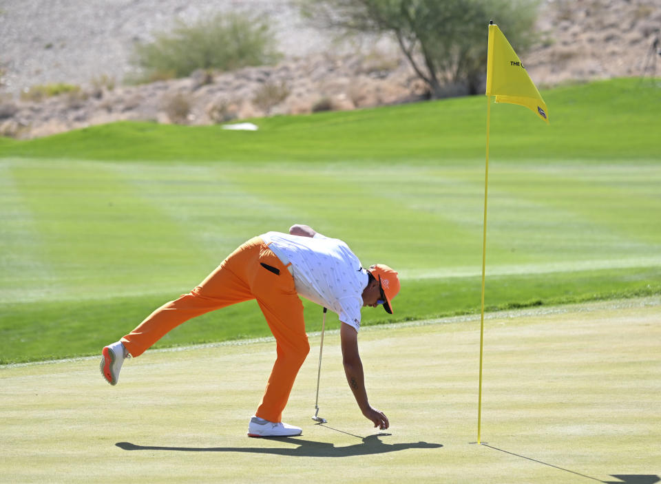 Rickie Fowler sets his ball on the fifth green during the final round of the CJ Cup golf tournament, Sunday, Oct. 17, 2021, in Las Vegas. (AP Photo/David Becker)