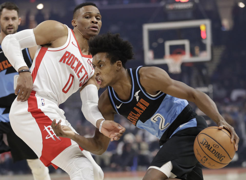Cleveland Cavaliers' Collin Sexton (2) drives past Houston Rockets' Russell Westbrook (0) in the first half of an NBA basketball game, Wednesday, Dec. 11, 2019, in Cleveland. (AP Photo/Tony Dejak)