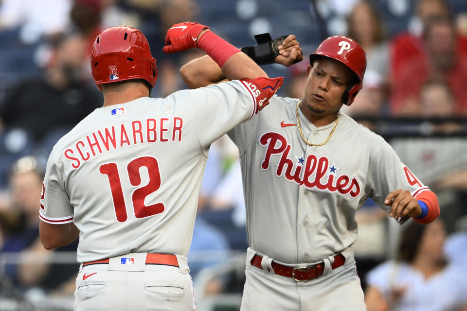 Philadelphia Phillies' Kyle Schwarber (12) celebrates his two-run home run with Yairo Munoz, right, during the third inning of the team's baseball game against the Washington Nationals, Thursday, June 16, 2022, in Washington. (AP Photo/Nick Wass)