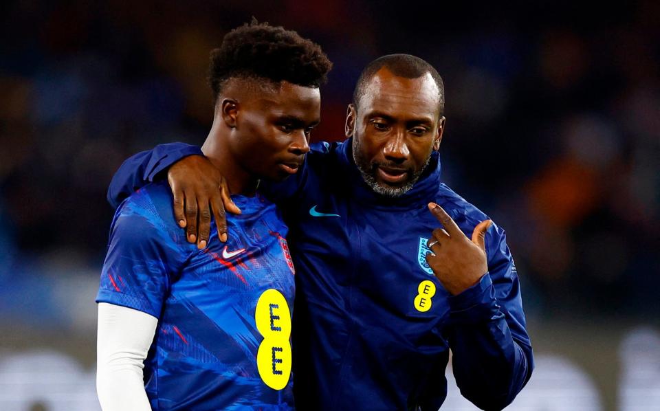 England coach Jimmy Floyd Hasselbaink speaks with Bukayo Saka before their Euro 2024 qualifier in Naples