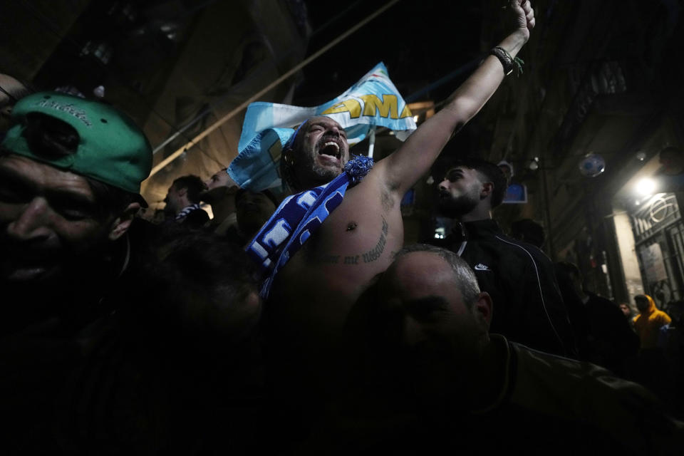 Napoli fans celebrates after Napoli's Victor Osimhen scored his side's first goal as they watch a screen live broadcasting Udinese Napoli Serie A soccer match, in Naples, Italy, Thursday, May 4, 2023. For the third time in five days, Napoli fans are hoping and preparing to celebrate the Italian league soccer title. (AP Photo/Andrew Medichini)