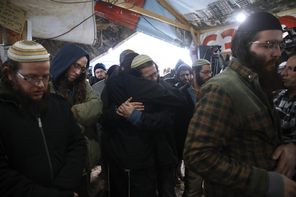 Mourners attend the funeral of Yehuda Dimentman, 25, who was killed in a shooting attack by a Palestinian gunman near the Jewish outpost of Homesh in the West Bank, Friday, Dec. 17, 2021. At least one Palestinian gunman opened fire Thursday night at a car filled with Jewish seminary students next to a West Bank settlement outpost, killing an Israeli man and lightly wounding two other people, Israeli officials said. (AP Photo/Moti Milrod)