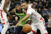 Toronto Raptors guard Norman Powell (24) and Minnesota Timberwolves forward Robert Covington (33) battle for the ball in the first quarter of an NBA basketball game Saturday, Jan. 18, 2020, in Minneapolis. (AP Photo/Andy Clayton-King)