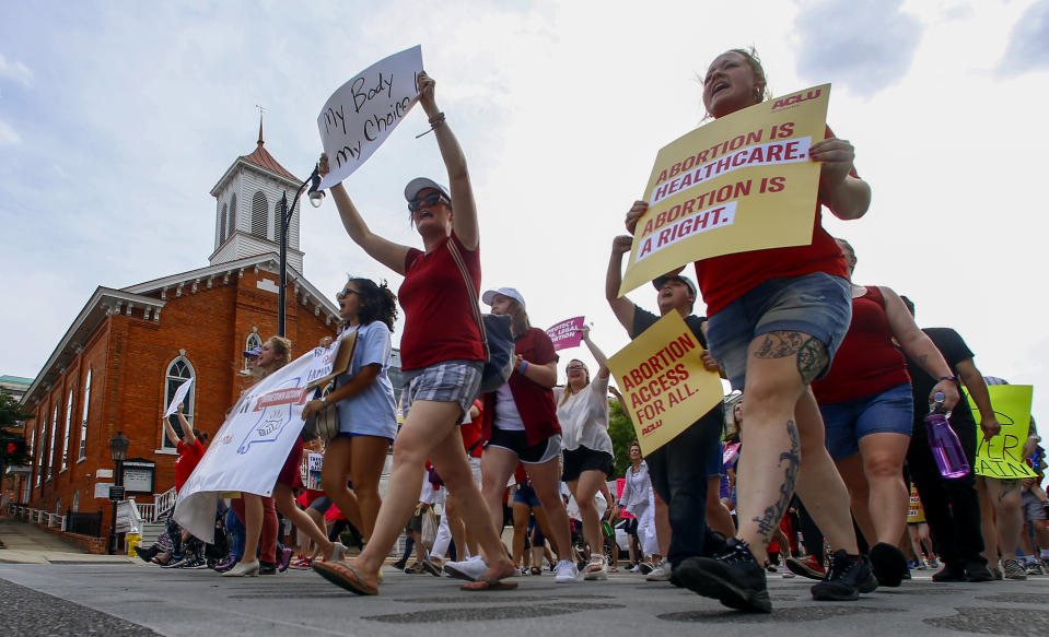 Protesters for women's rights march past Dexter Avenue Baptist Church to the Alabama Capitol to protest a law passed last week making abortion a felony in nearly all cases with no exceptions for cases of rape or incest, Sunday, May 19, 2019, in Montgomery, Ala. (AP Photo/Butch Dill)