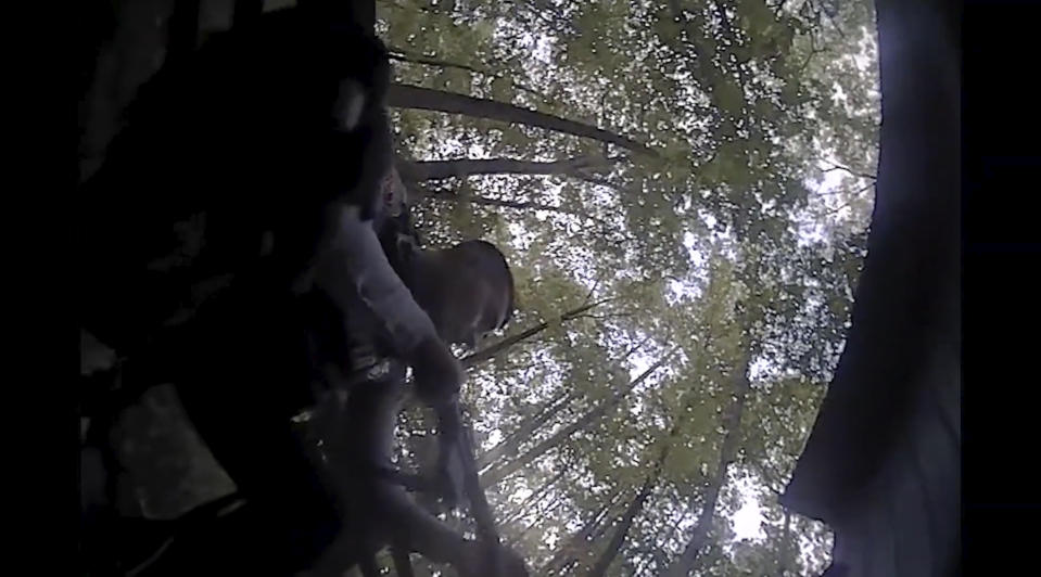 This screengrab of body camera footage provided by the Raleigh, N.C., Police Department shows a shootout that nonfatally struck one officer. On Thursday, Dec. 1, 2022, seven weeks after a 15-year-old boy fatally shot five people and injured two in an East Raleigh neighborhood, the police department released body camera footage of the shootout that occurred Oct. 13, prior to police apprehending the suspect in a shed. (Raleigh Police Department via AP)