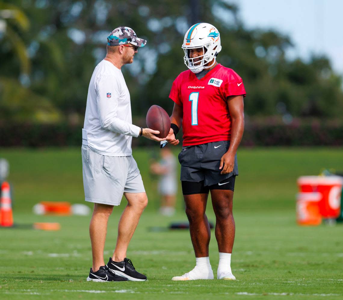Miami Dolphins quarterbacks coach and passing game coordinator Darrell Bevell talks Dolphins quarterback Tua Tagovailoa (1) during practice at Baptist Health Training Complex in Hard Rock Stadium on Wednesday, November 30, 2022 in Miami Gardens, Florida.