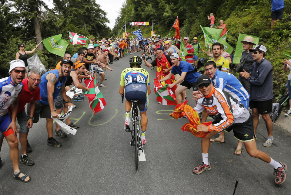 fans at Tour de France cheer climbing rider