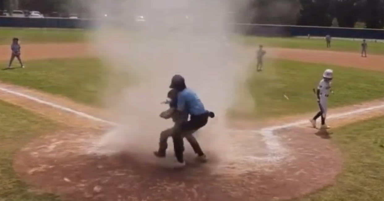 Umpire pulls young baseball player from dust storm (Courtesy Scott Wiles)