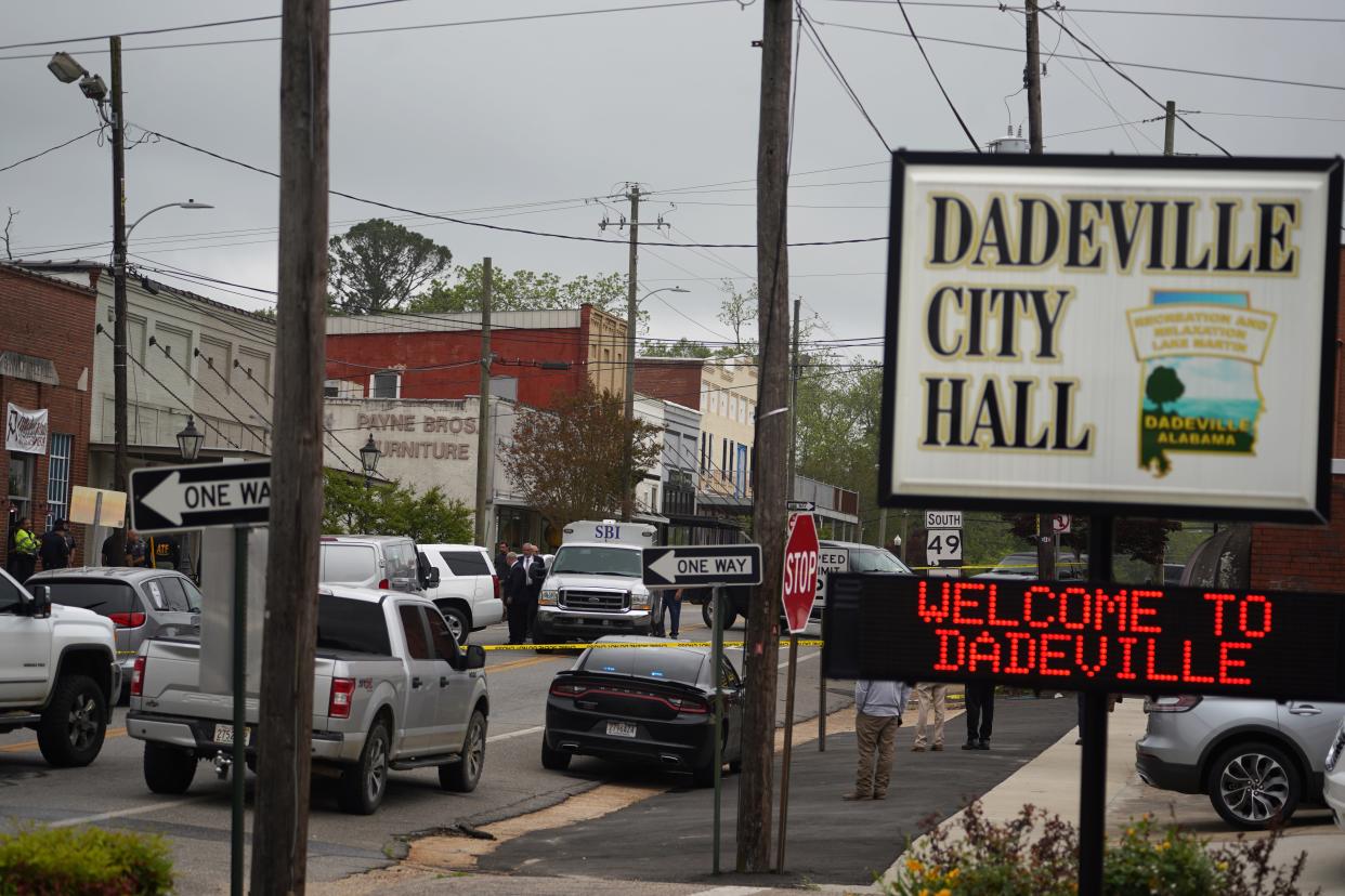 Community members watch as crime scene investigators work the scene (16 April 2023) (Getty Images)